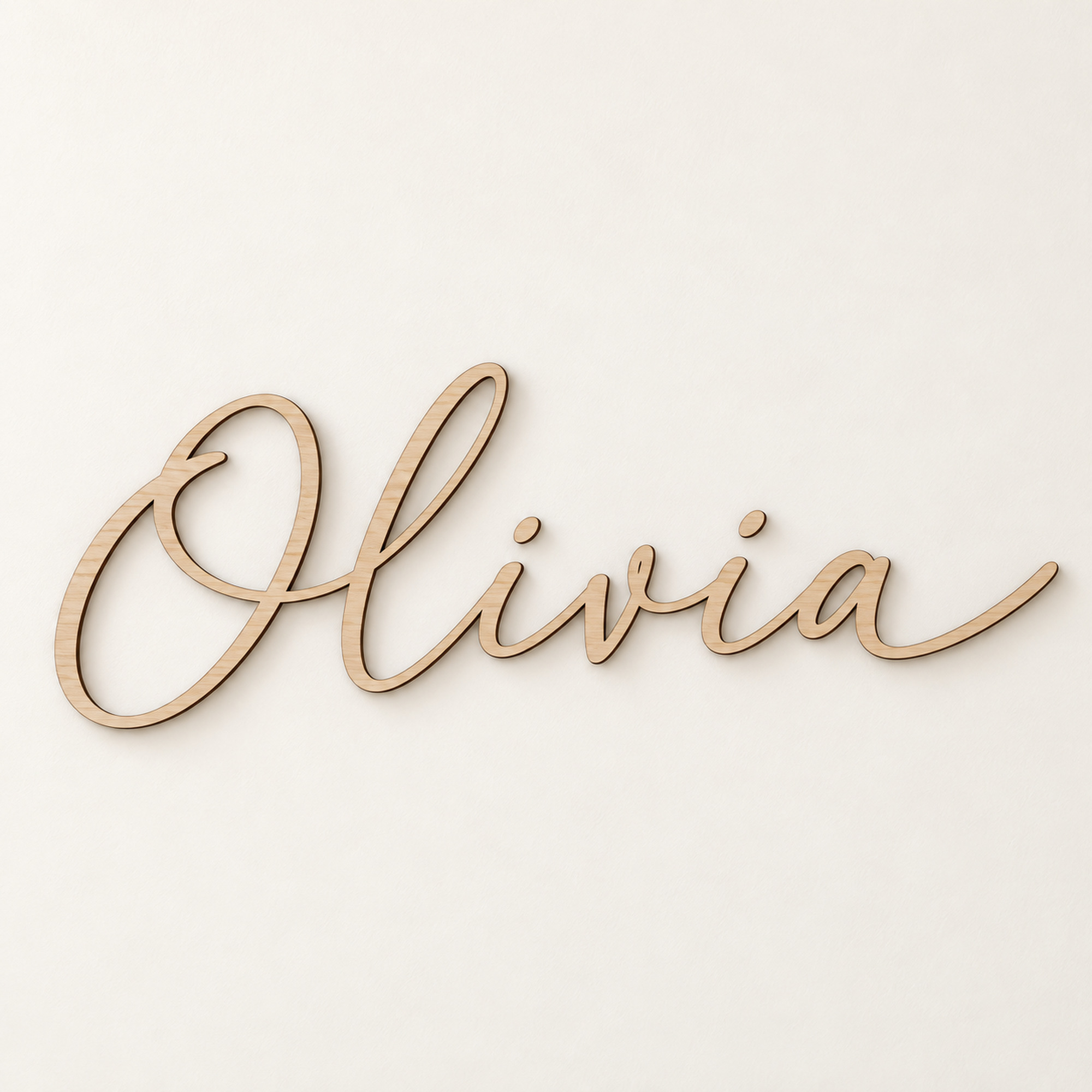 Cut out wooden name sign reading Olivia in script lettering in Barewood Natural, on a plain off-white background.